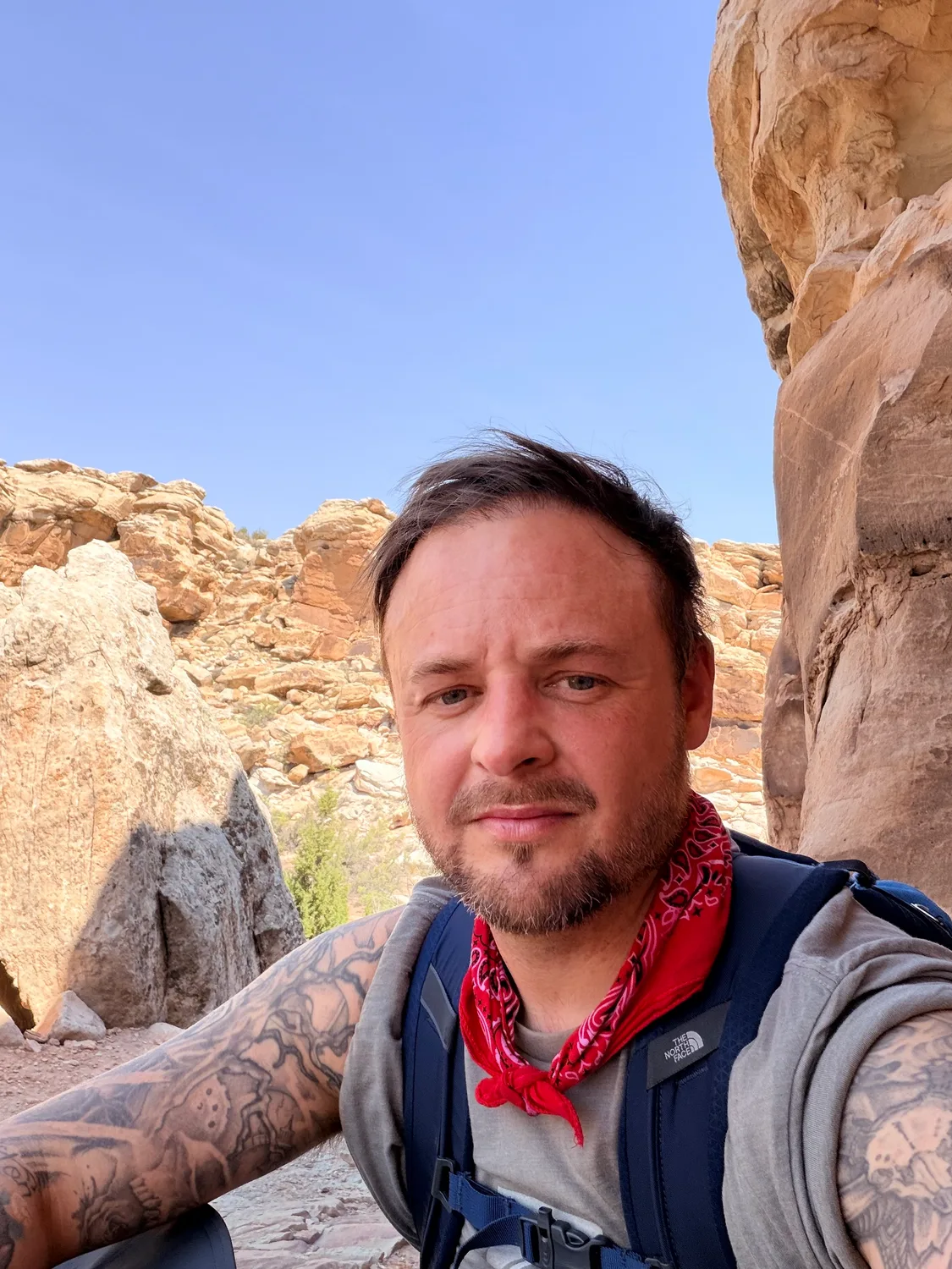 Brison McPhail beneath a sandstone arch in Utah