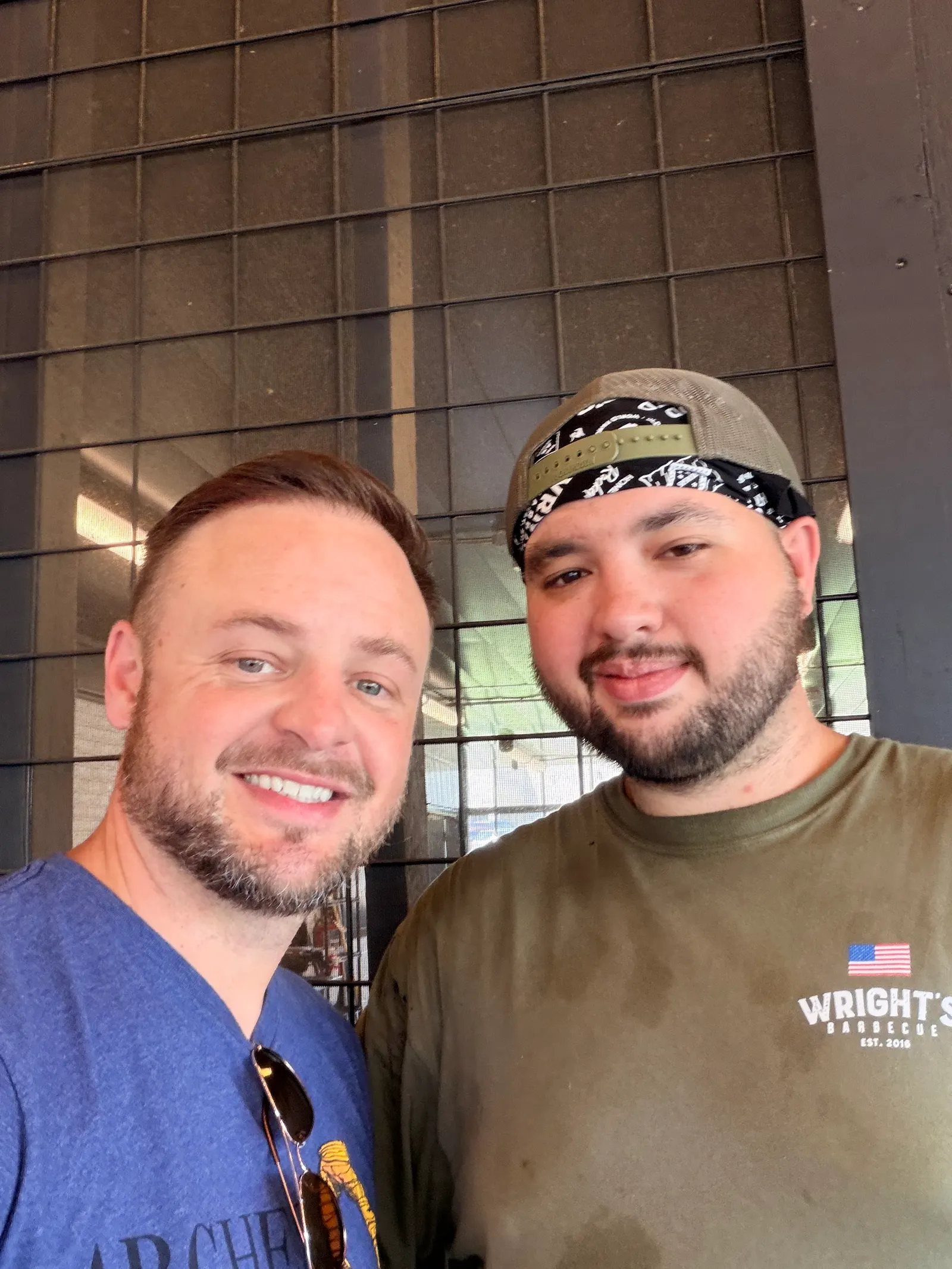 Brison McPhail and Wright's Barbecue pitmaster James Roach smiling in the pit room at the Benton location