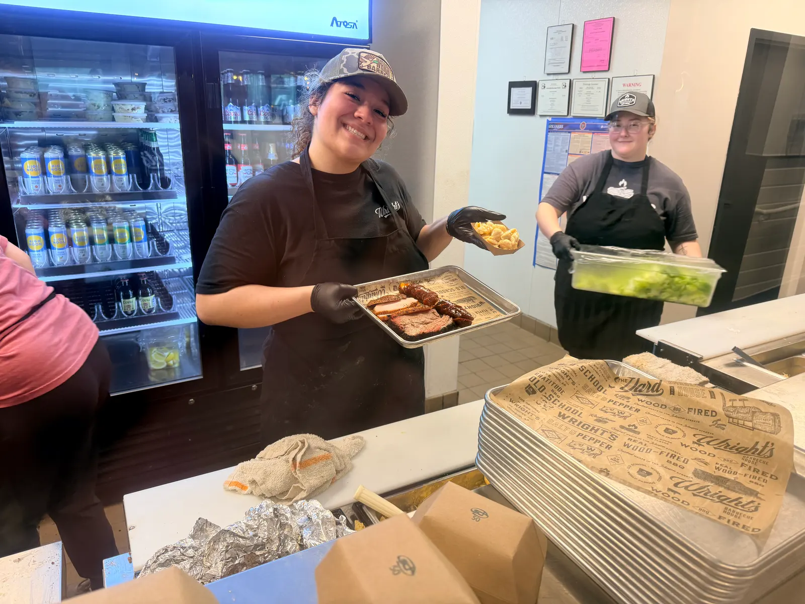 The crew at the Wright's Barbecue counter in Benton with a loaded tray ready to serve