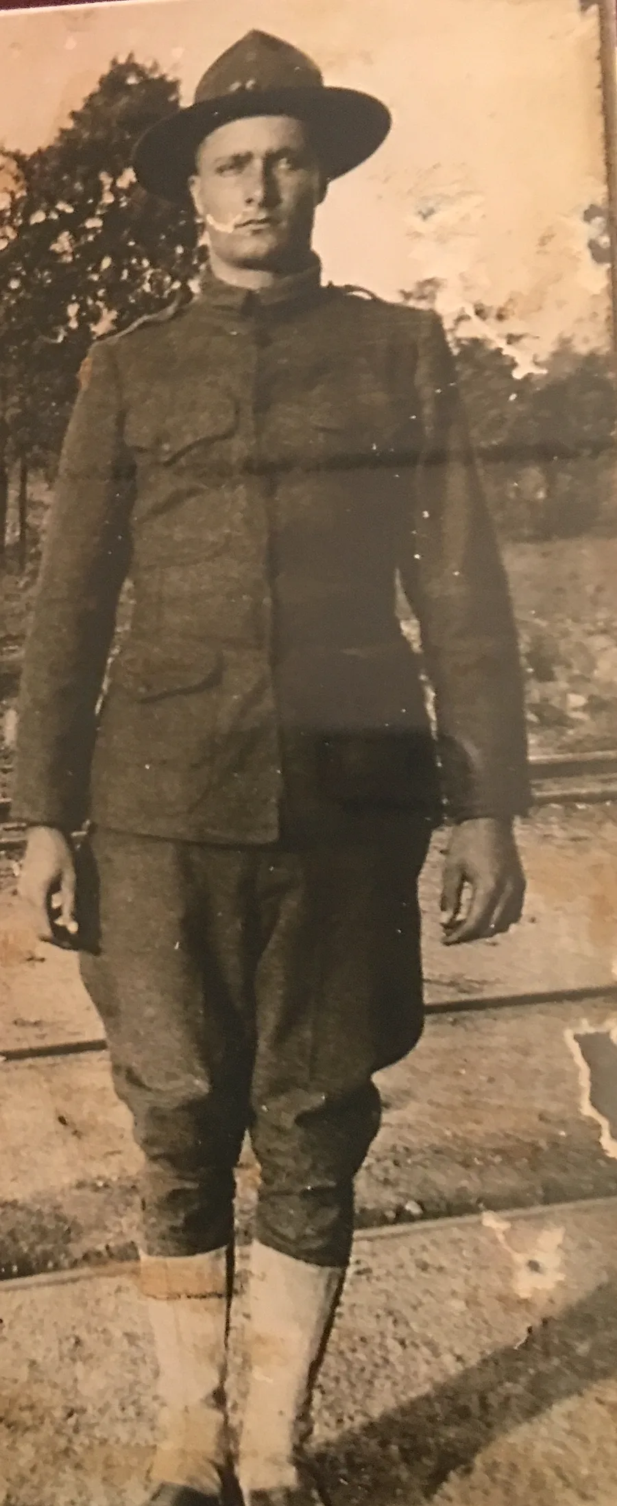 Brison McPhail's great-grandfather standing at attention in a World War I–era U.S. Army uniform with campaign hat, wool tunic, and puttees