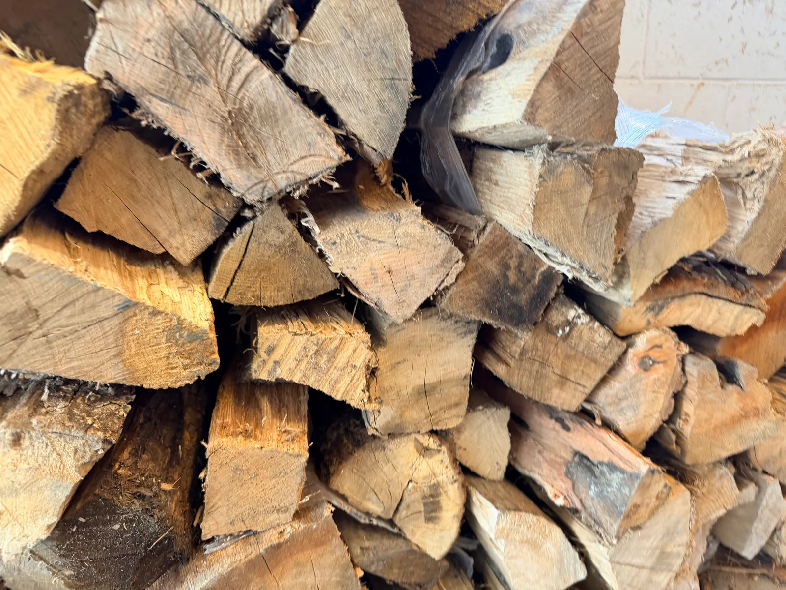 A stack of split oak firewood staged for the smokers at Wright's Barbecue in Benton