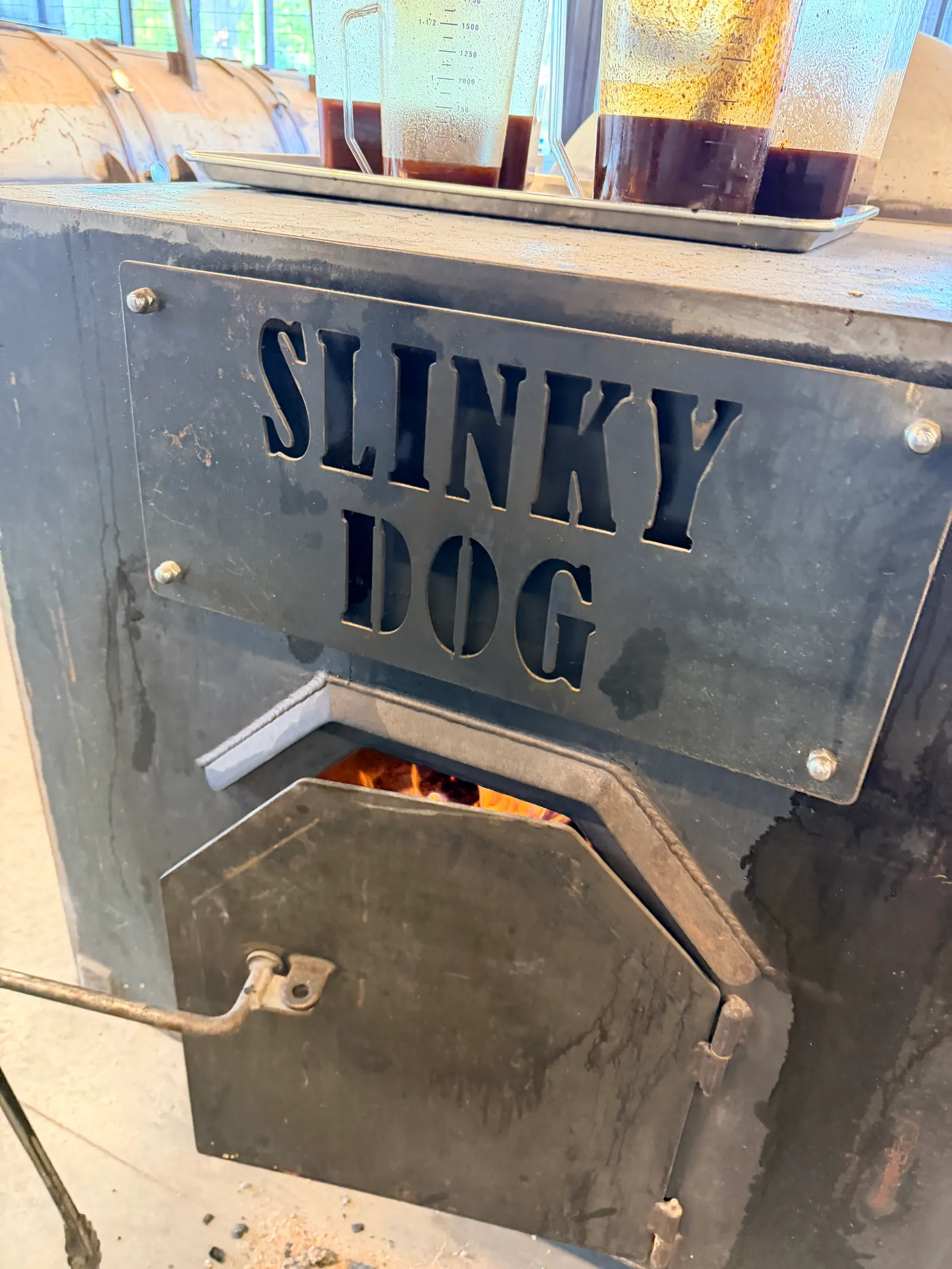 A Wright's Barbecue smoker firebox with the name Slinky Dog painted on it
