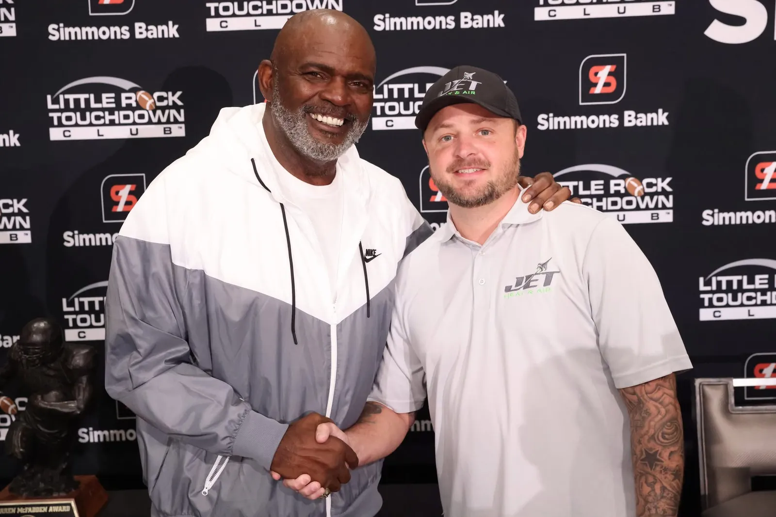 Brison McPhail of Jet Heat and Air shaking hands with NFL Hall of Famer Lawrence Taylor at the Little Rock Touchdown Club