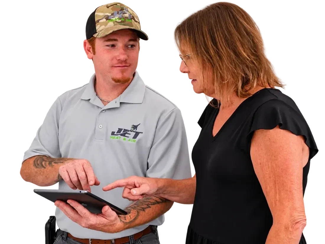 Jet Heat and Air technician showing a homeowner the price on a tablet before work starts