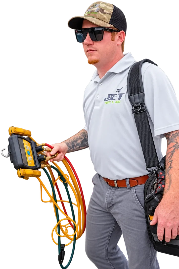 Jet Heat and Air technician on the way with gauges and a tool bag